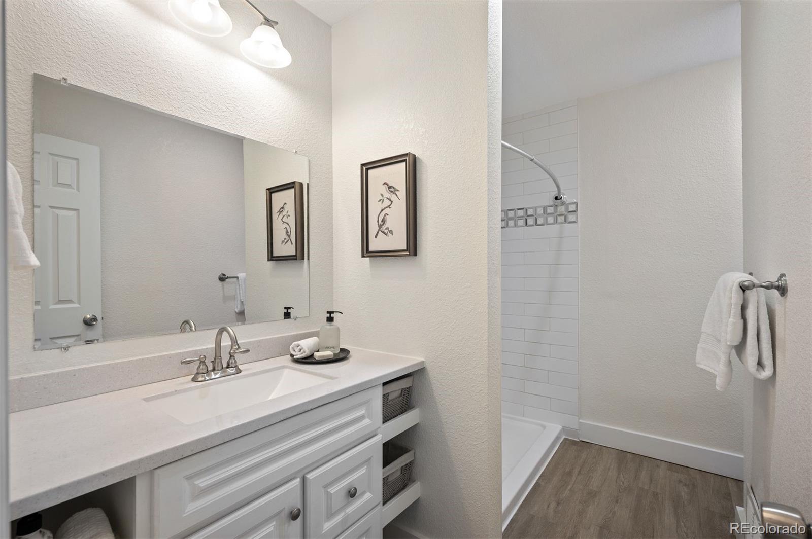 1422 Quebec Street Denver, CO 80220 - Photo 9 of 19 a bathroom with a sink and mirror