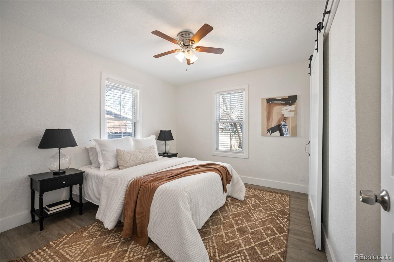 1422 Quebec Street Denver, CO 80220 - Photo 10 of 19 a bedroom with a bed and a lamp