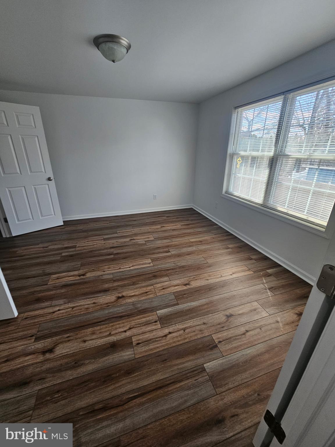 683 Easton Road, Unit B Riegelsville, PA 18077 - Photo 5 of 9 a view of an empty room with wooden floor and a window