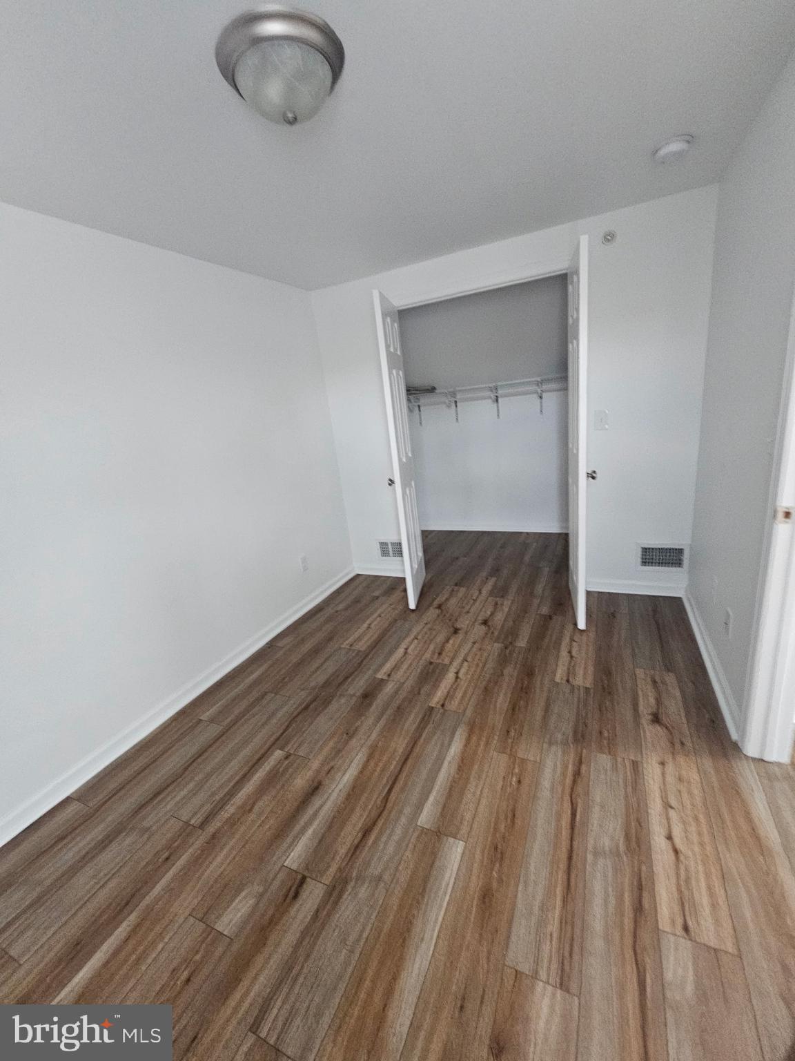 683 Easton Road, Unit B Riegelsville, PA 18077 - Photo 6 of 9 a view of a room with wooden floor and white walls