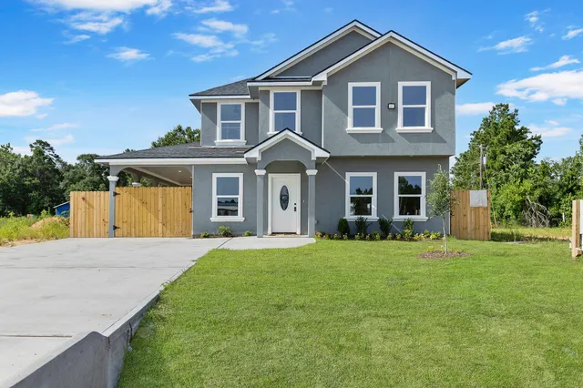 a front view of a house with a garden