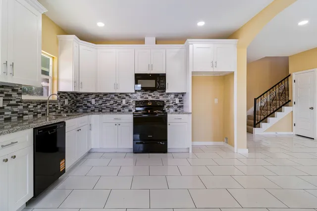 a kitchen with a stove a sink and a refrigerator