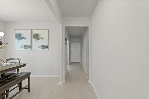 a view of room with workspace and wooden floor