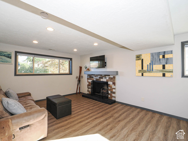 3308 Willow Ridge Road Salt Lake City, UT 84121 - Photo 48 of 59 Wood-finish flooring with a stone-clad fireplace and a contrasting mantel