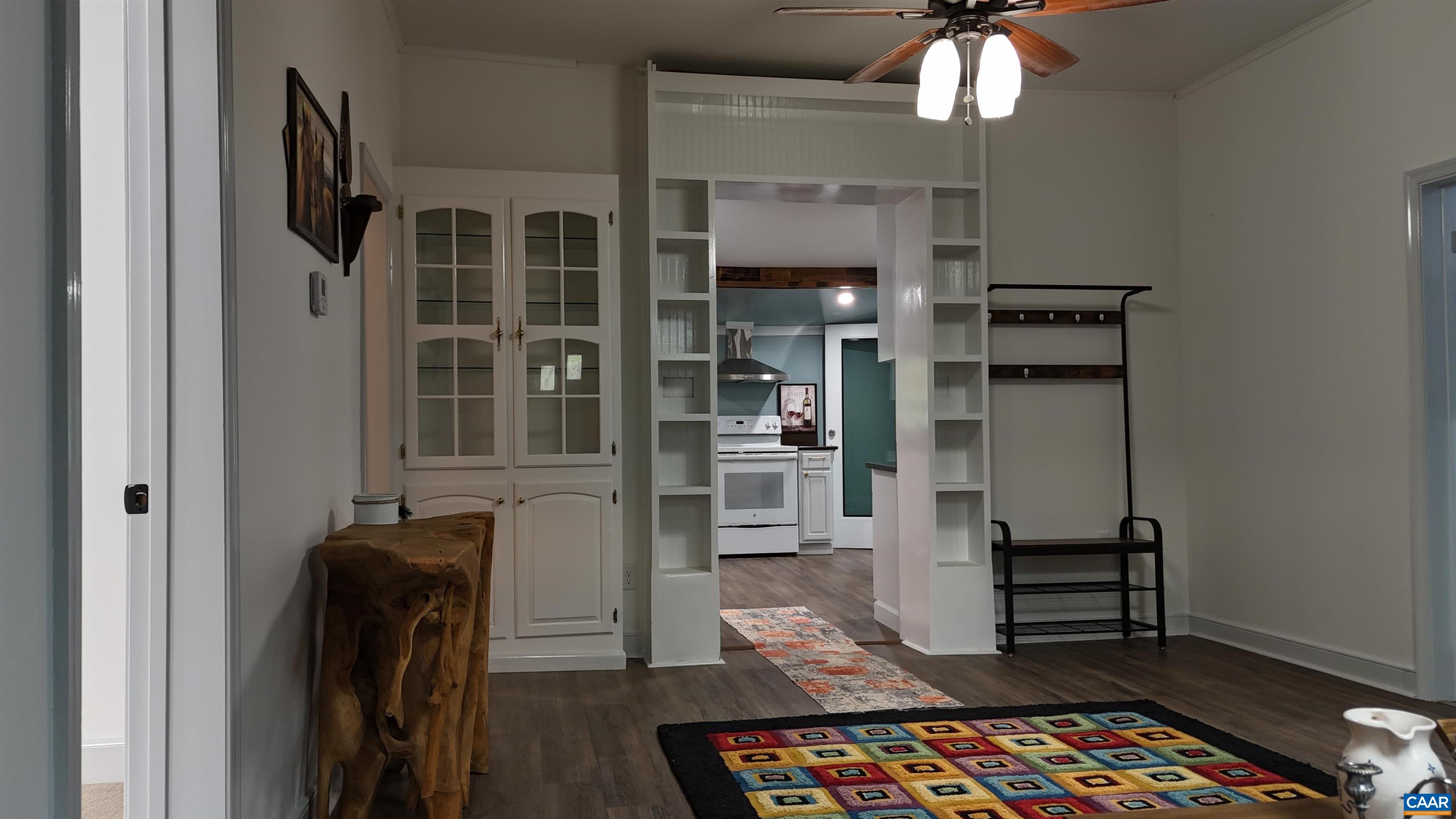 7559 Esmont Road Esmont, VA 22937 - Photo 13 of 22 a view of a hallway with wooden floor and a chandelier