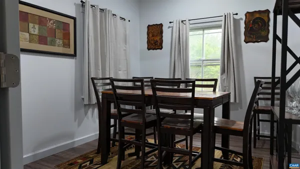 a view of a dining room with furniture and window