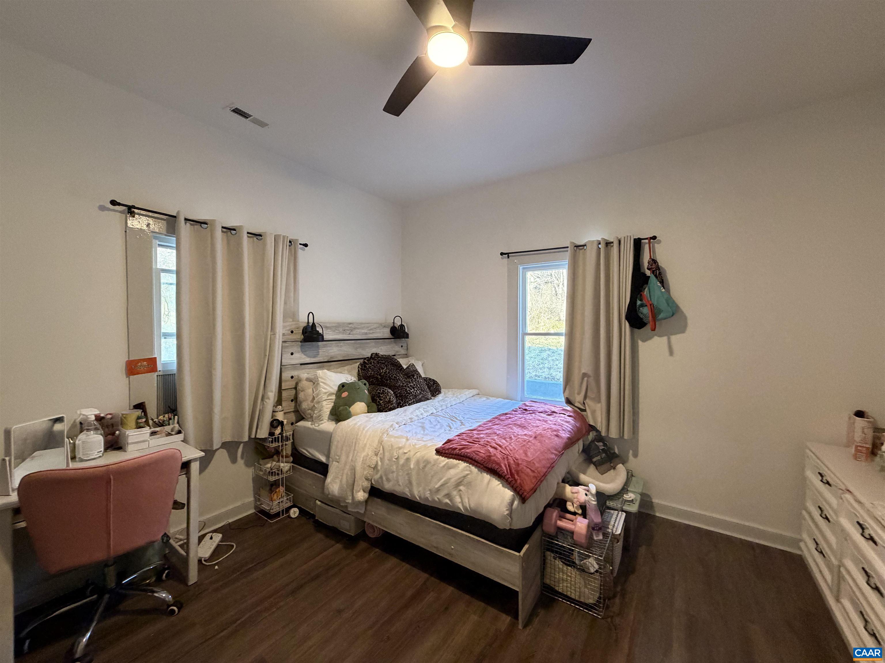 7559 Esmont Road Esmont, VA 22937 - Photo 17 of 22 a bedroom with a bed and a chandelier