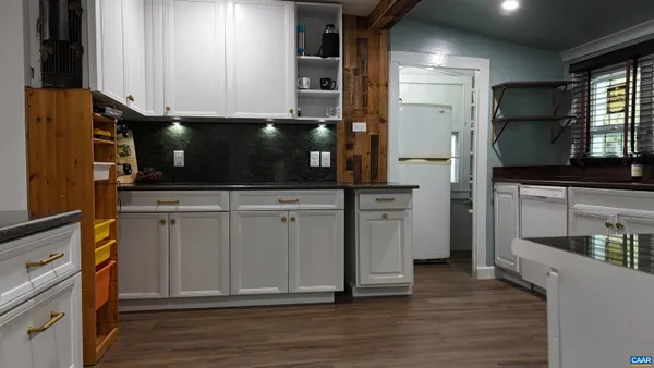 a kitchen with stainless steel appliances a microwave and cabinets