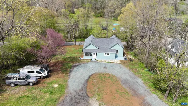 an aerial view of a house with a garden and deck