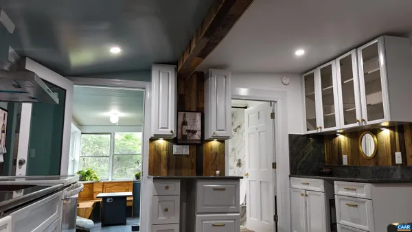 a kitchen with stainless steel appliances kitchen island granite countertop a refrigerator stove and sink