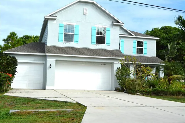a front view of a house with a yard and garage