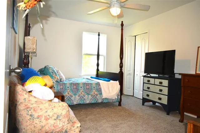 a bedroom with furniture and a flat screen tv