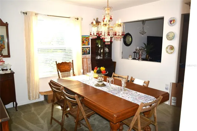 a dining room with furniture and window