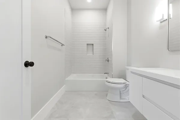a bathroom with a toilet sink and shower