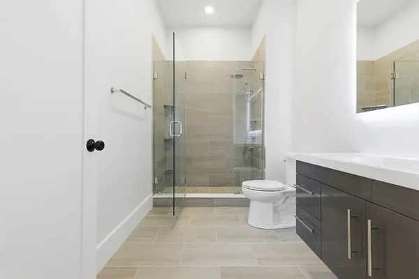 a bathroom with a toilet sink and shower