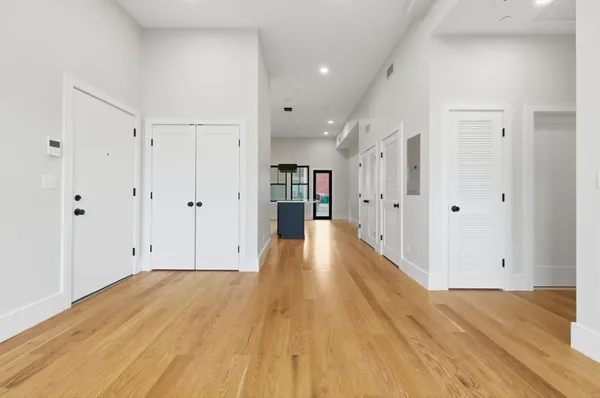 a view of empty room with wooden floor