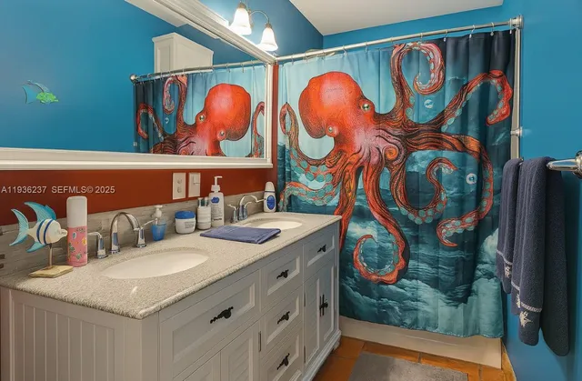 a bathroom with a sink and mirror