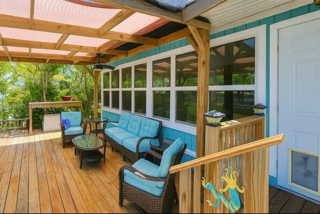 a balcony with chairs and wooden floor
