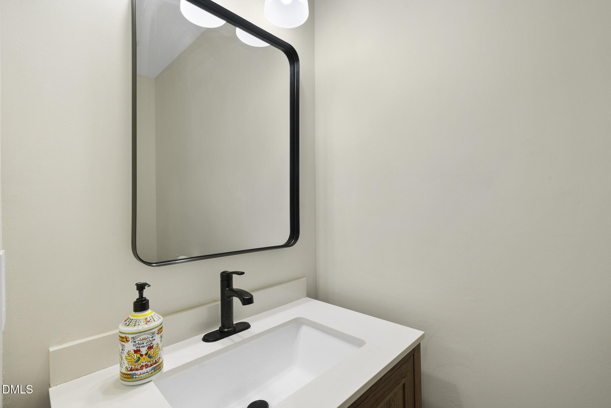 6108 New Market Way Raleigh, NC 27609 - Photo 12 of 31 a bathroom with a sink and a mirror