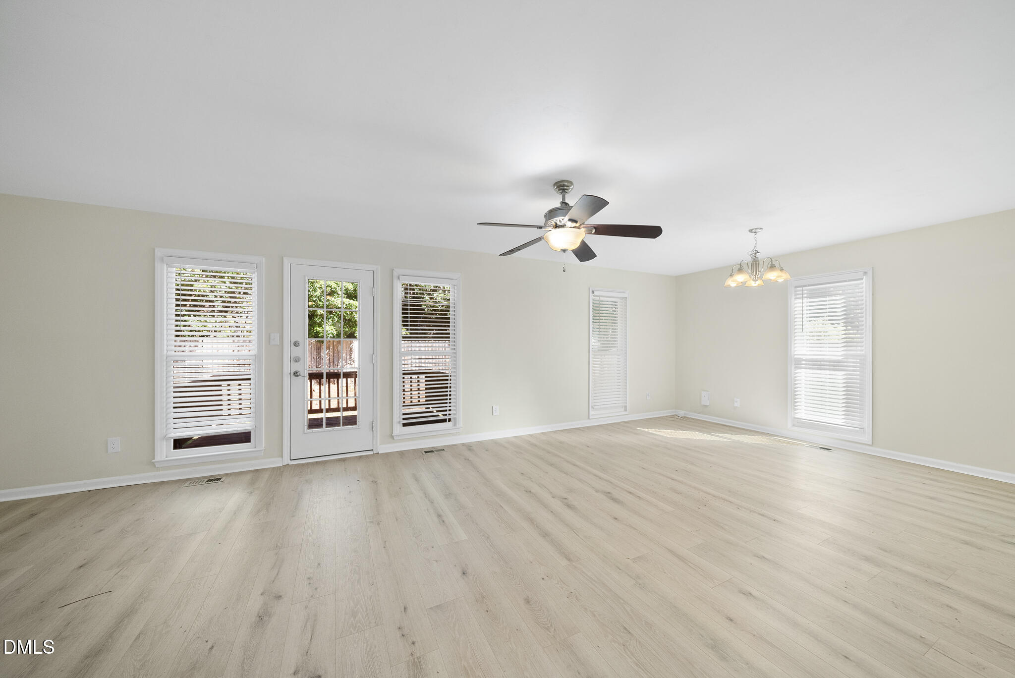 6108 New Market Way Raleigh, NC 27609 - Photo 13 of 31 wooden floor in an empty room with a window