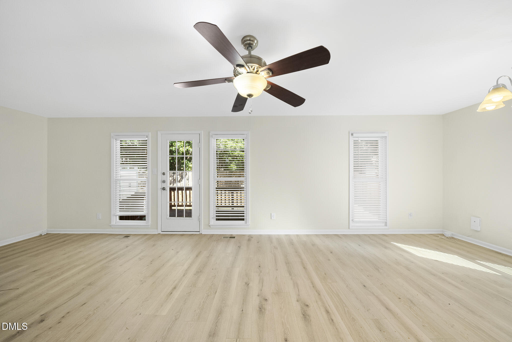 6108 New Market Way Raleigh, NC 27609 - Photo 14 of 31 a view of an empty room with wooden floor and a window