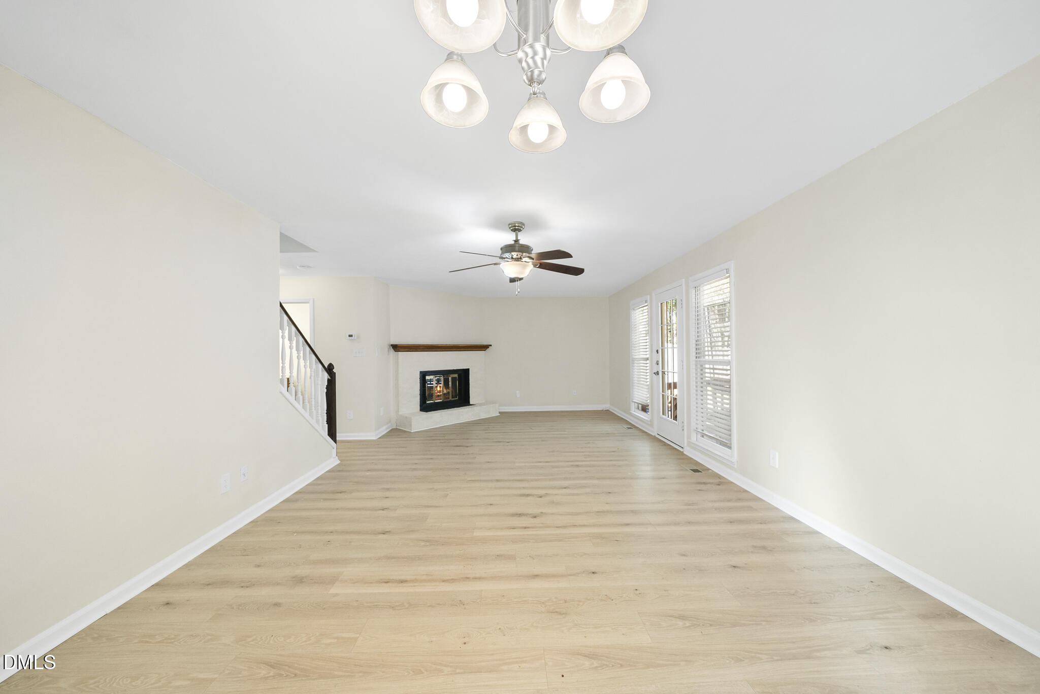 6108 New Market Way Raleigh, NC 27609 - Photo 16 of 31 a view of an empty room with a chandelier fan