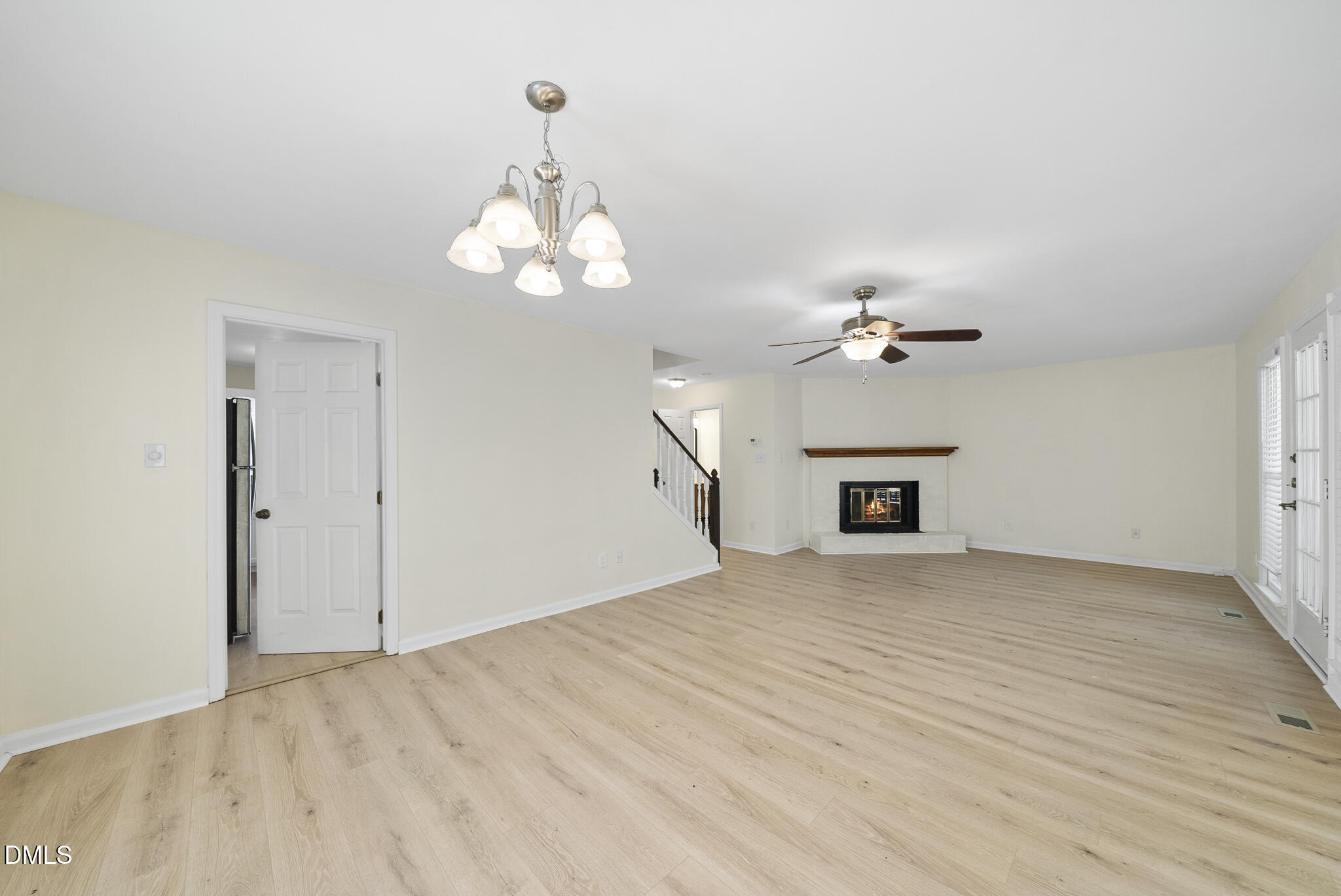 6108 New Market Way Raleigh, NC 27609 - Photo 17 of 31 a view of an empty room with a chandelier fan