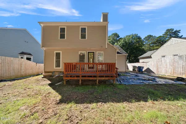 an empty room with wooden floor ceiling fan and windows