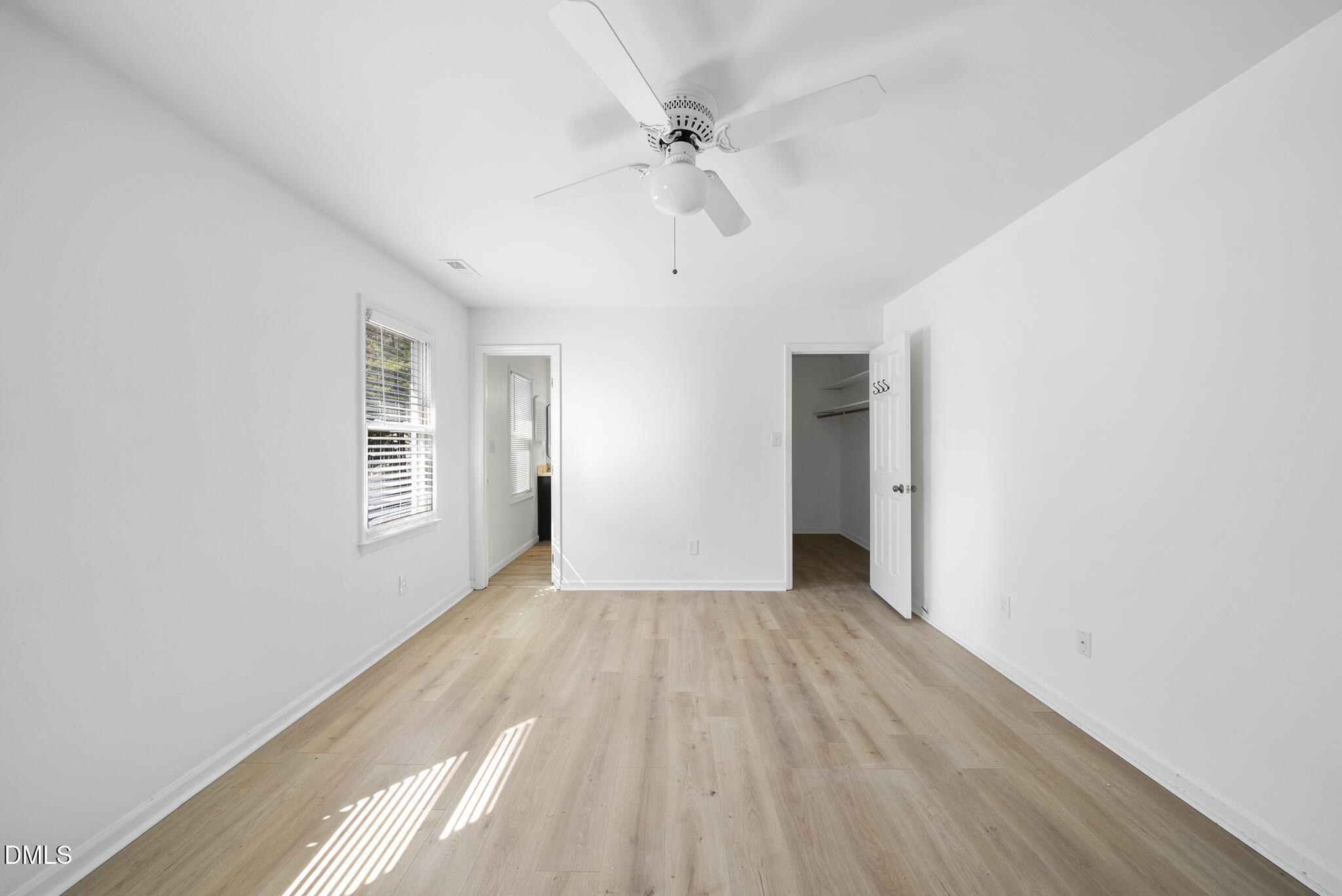 6108 New Market Way Raleigh, NC 27609 - Photo 22 of 31 wooden floor in an empty room with a window