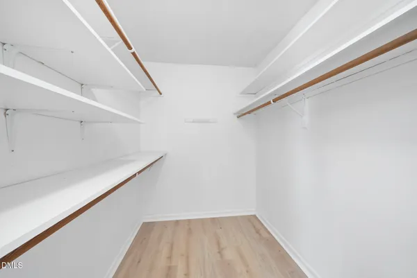 a bathroom with a toilet a sink a mirror and vanity