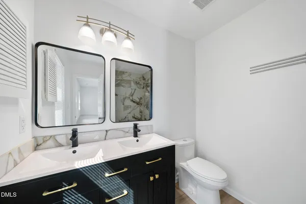 a white toilet sitting next to a shower curtain