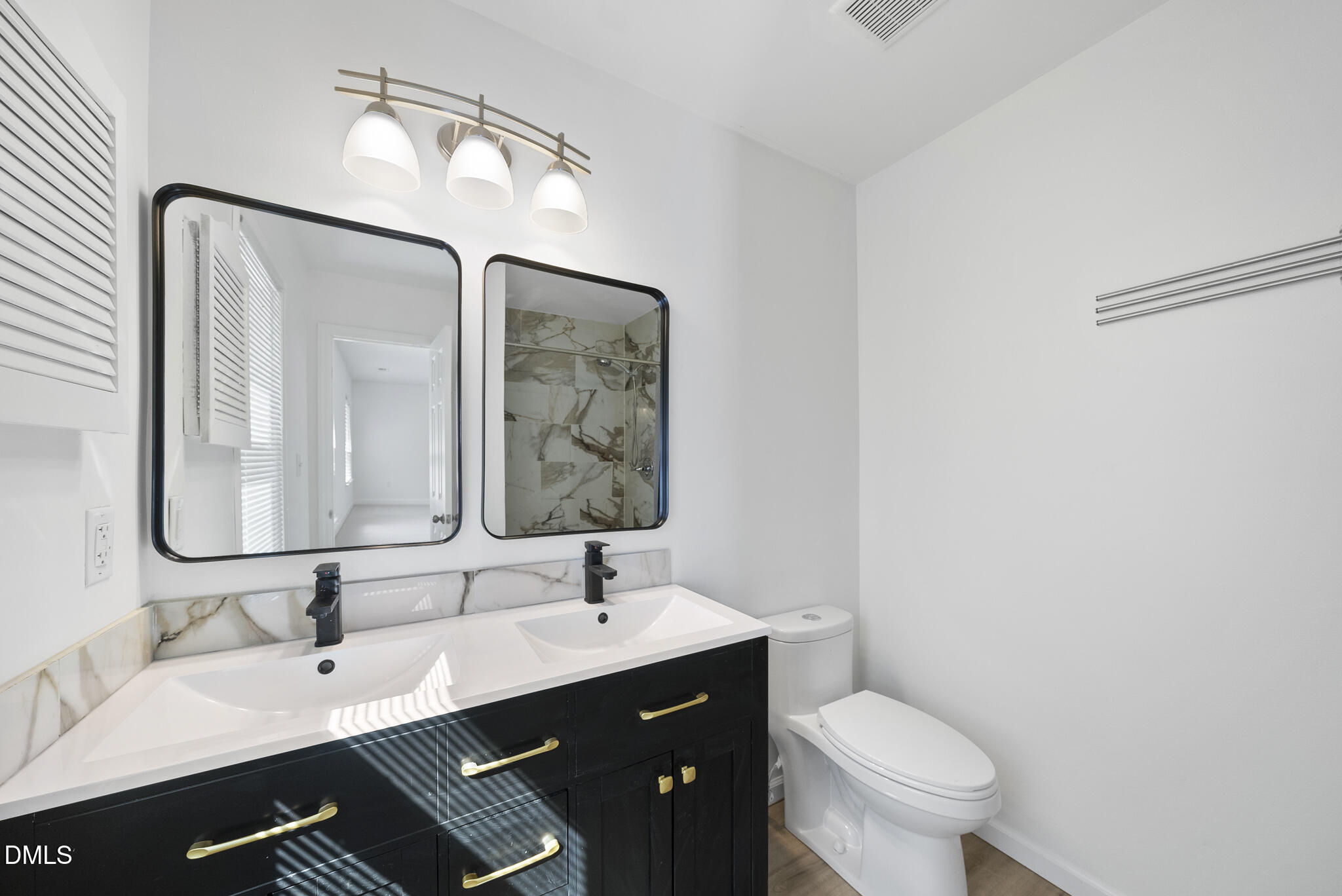 6108 New Market Way Raleigh, NC 27609 - Photo 25 of 31 a bathroom with a toilet a sink a mirror and vanity
