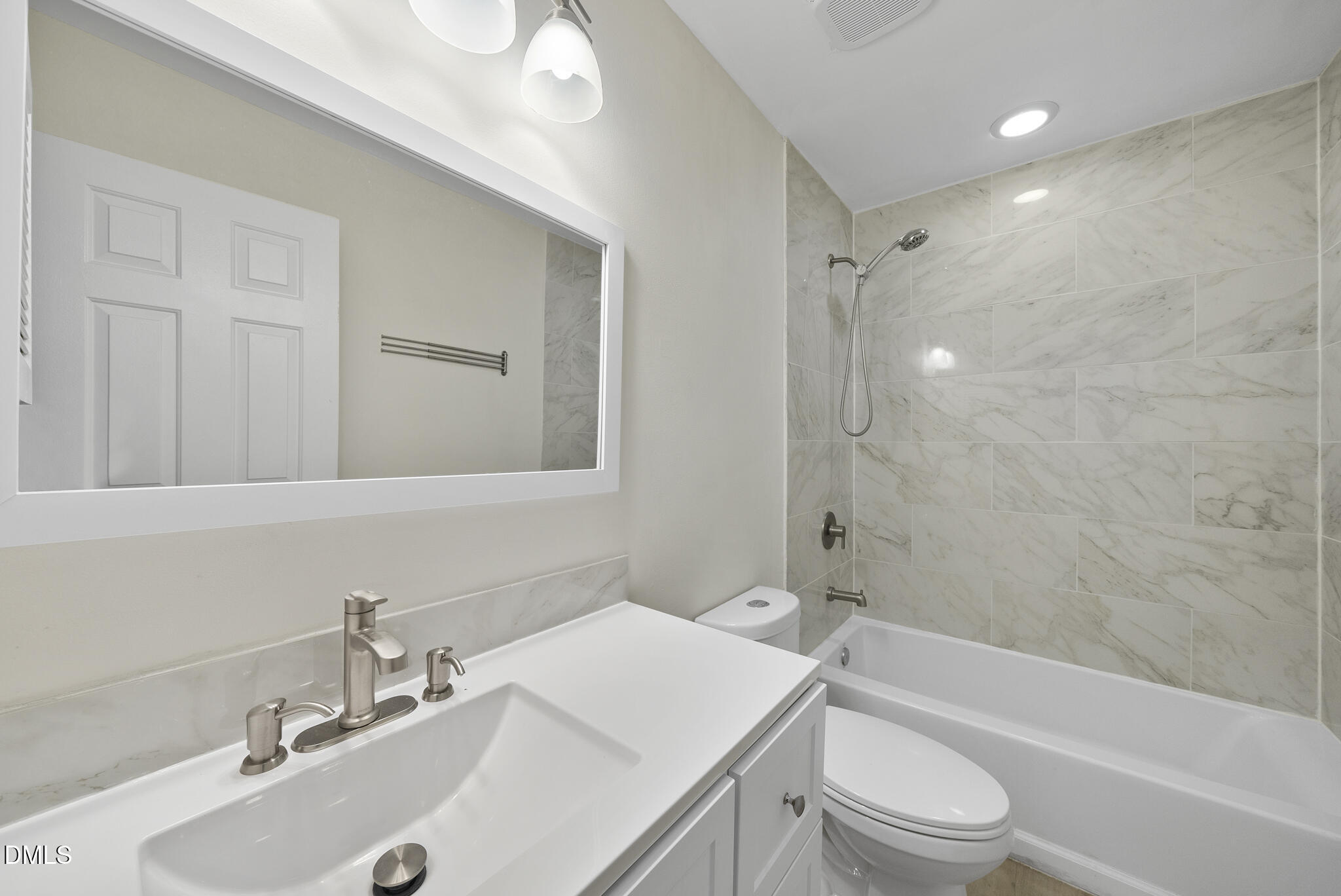 6108 New Market Way Raleigh, NC 27609 - Photo 31 of 31 a bathroom with a sink a toilet and shower