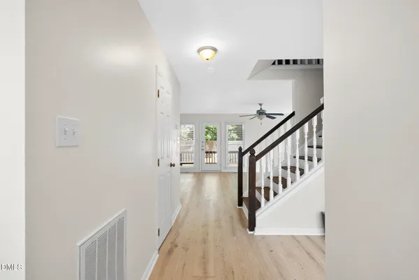 a view of entryway and hall with wooden floor