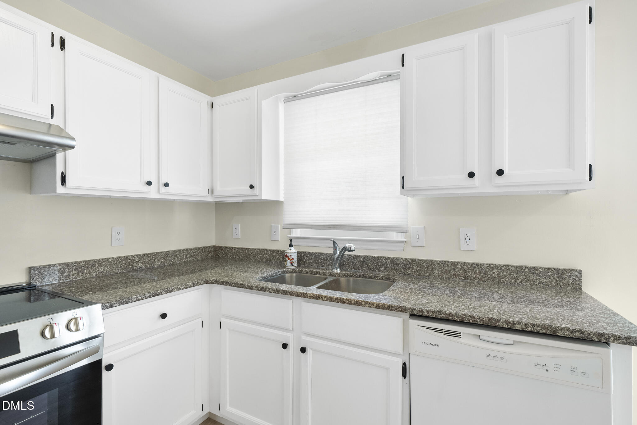 6108 New Market Way Raleigh, NC 27609 - Photo 8 of 31 a kitchen with granite countertop white cabinets and a sink