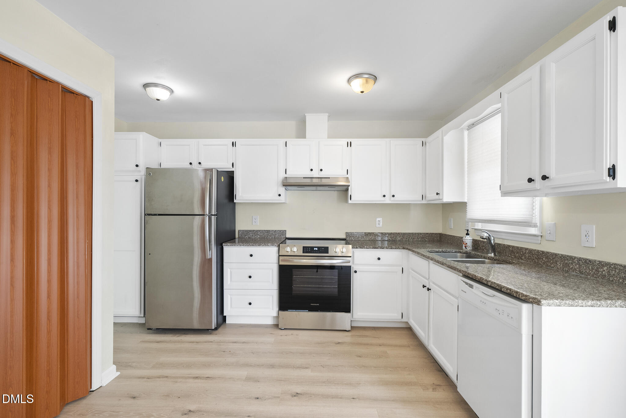 6108 New Market Way Raleigh, NC 27609 - Photo 10 of 31 a kitchen with a refrigerator sink and white cabinets