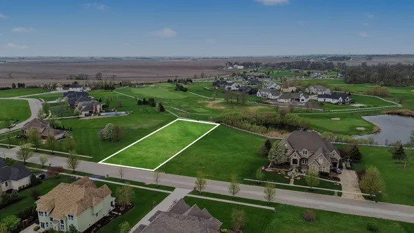 an aerial view of a golf course with chairs