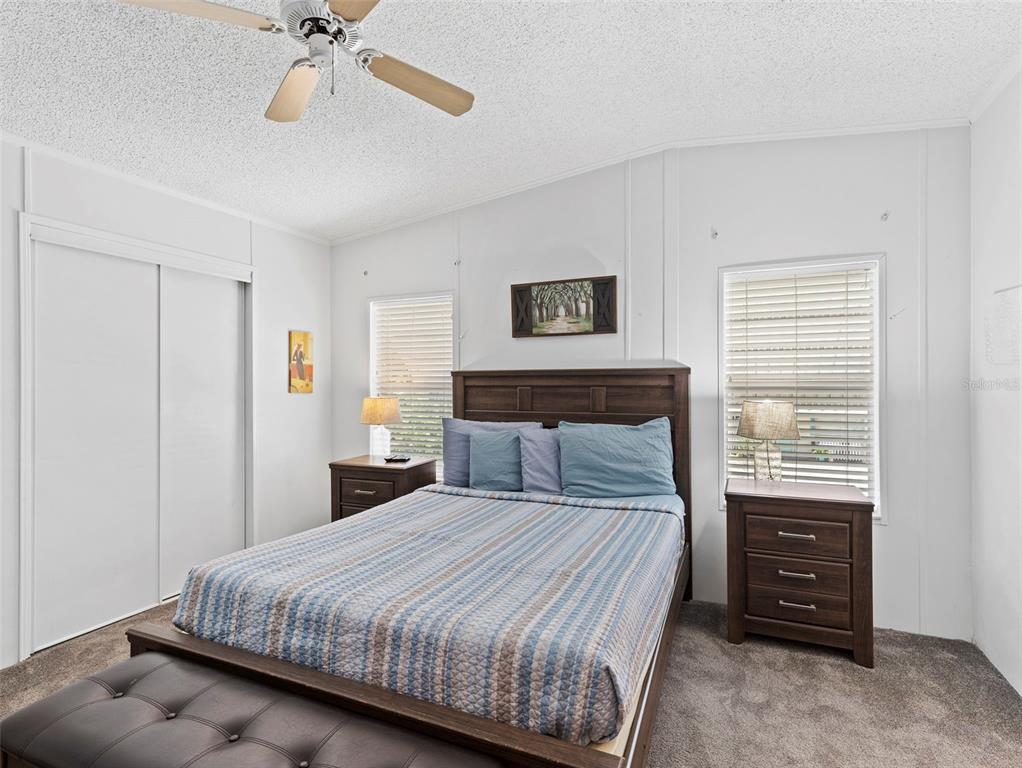 6297 Fine Street Weeki Wachee, FL 34607 - Photo 17 of 52 a bedroom with a bed and a chandelier