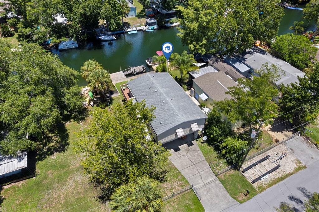 6297 Fine Street Weeki Wachee, FL 34607 - Photo 2 of 52 an aerial view of a house with a garden and lake view