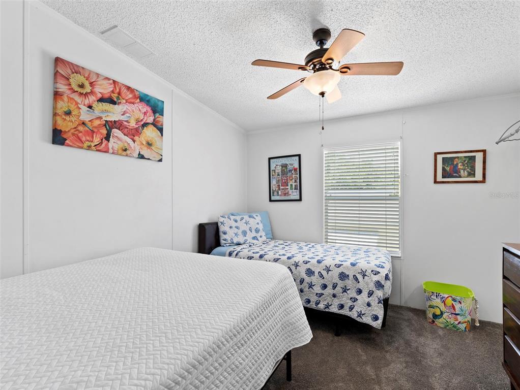 6297 Fine Street Weeki Wachee, FL 34607 - Photo 23 of 52 a bedroom with a bed and a chandelier