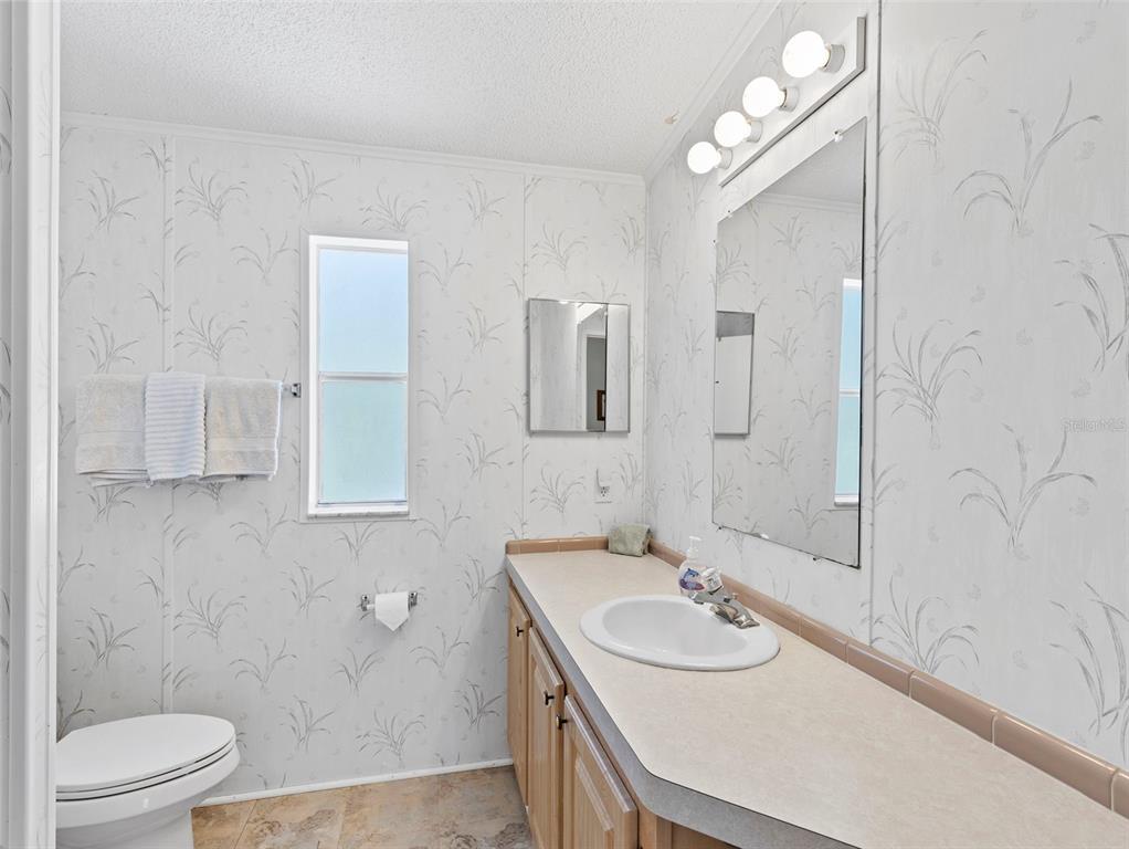 6297 Fine Street Weeki Wachee, FL 34607 - Photo 24 of 52 a bathroom with a sink a toilet and shower