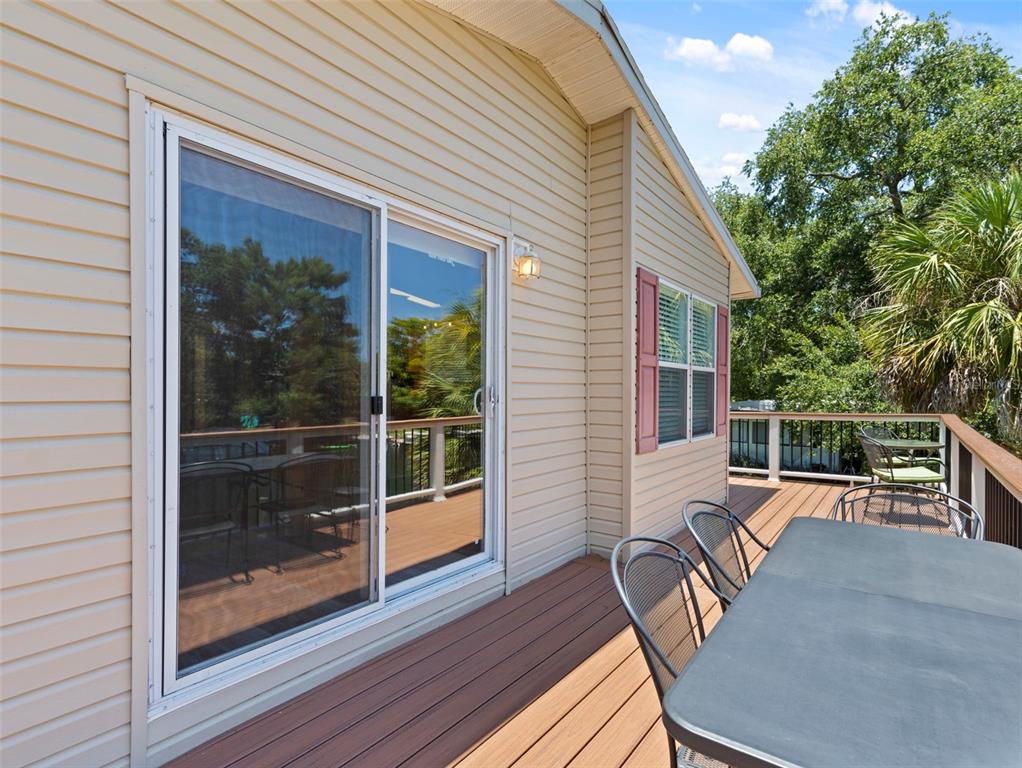 6297 Fine Street Weeki Wachee, FL 34607 - Photo 29 of 52 a porch with wooden floor and outdoor space