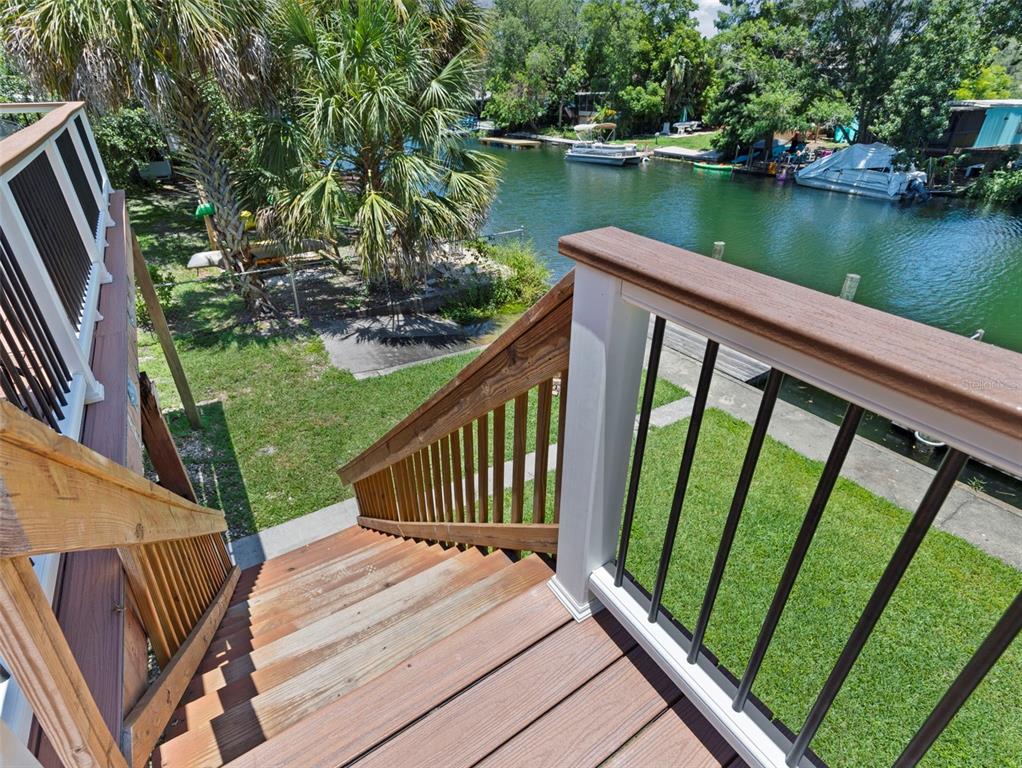 6297 Fine Street Weeki Wachee, FL 34607 - Photo 30 of 52 a view of a wooden deck next to a lake