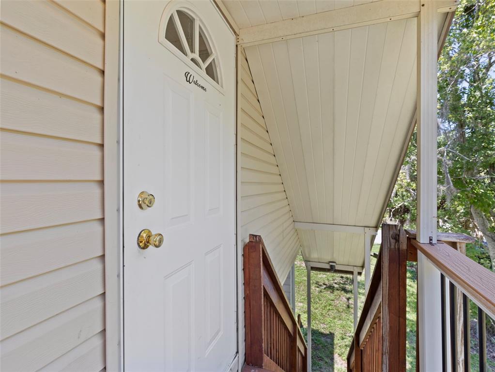 6297 Fine Street Weeki Wachee, FL 34607 - Photo 4 of 52 a view of balcony with wooden floor and stairs