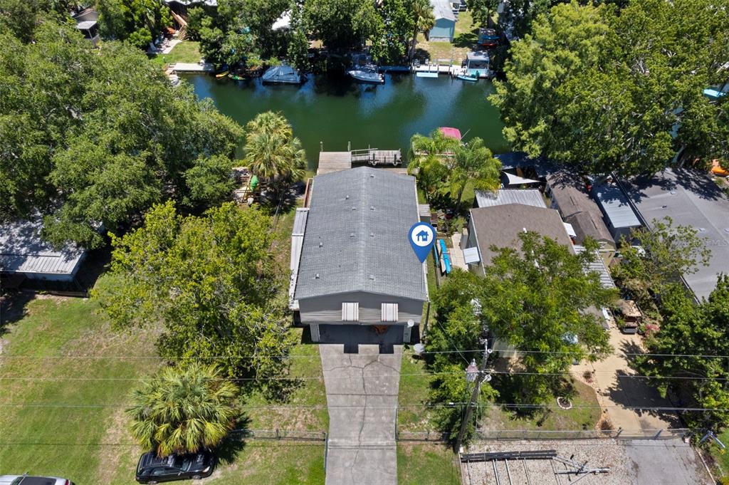 6297 Fine Street Weeki Wachee, FL 34607 - Photo 43 of 52 an aerial view of a house with a garden and lake view
