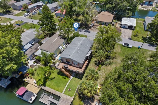 an aerial view of a houses with a yard
