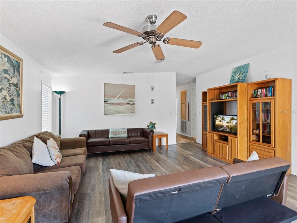6297 Fine Street Weeki Wachee, FL 34607 - Photo 8 of 52 a living room with furniture and a flat screen tv with wooden floor
