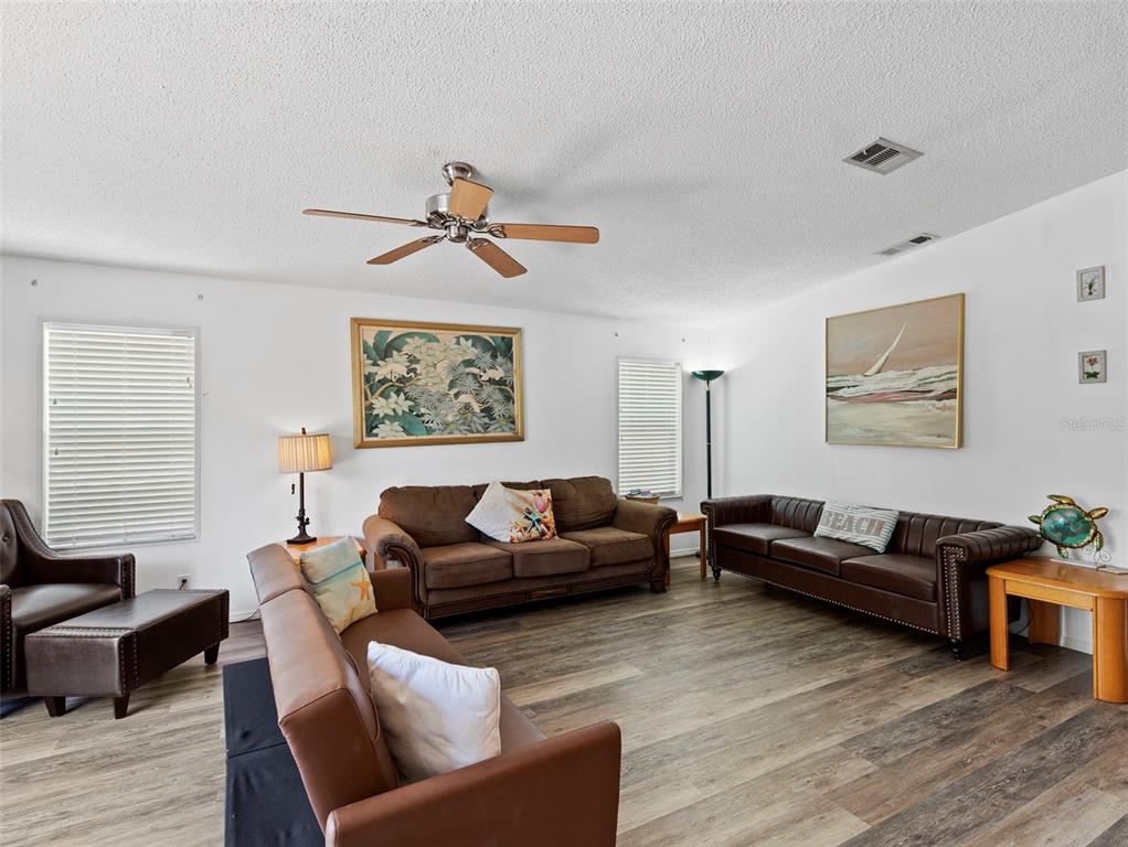 6297 Fine Street Weeki Wachee, FL 34607 - Photo 9 of 52 a living room with furniture and a painting on the wall