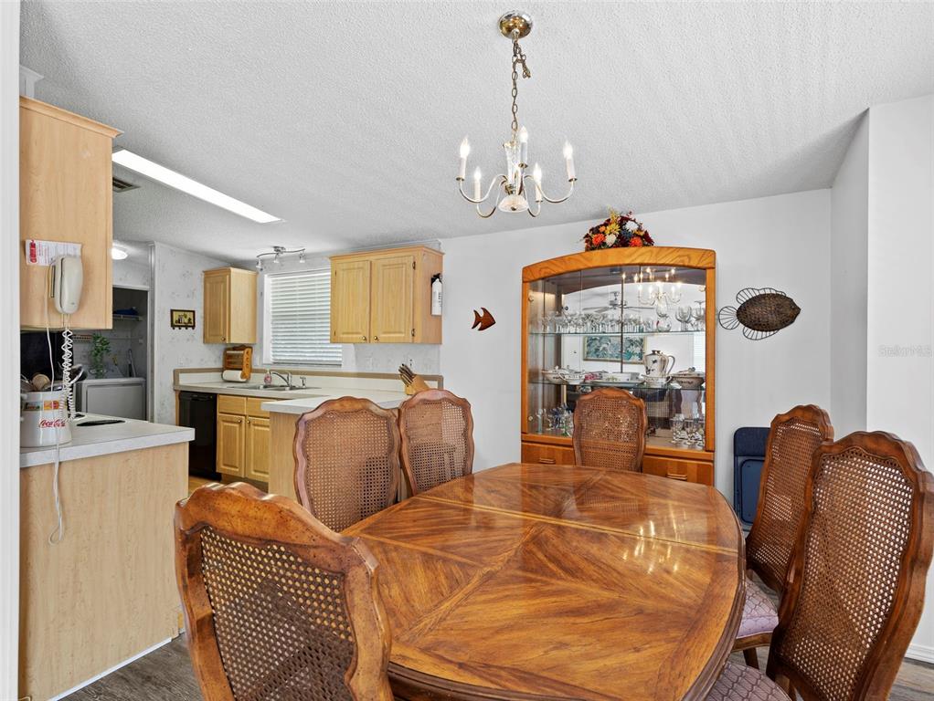 6297 Fine Street Weeki Wachee, FL 34607 - Photo 10 of 52 a dining room with furniture a chandelier and window