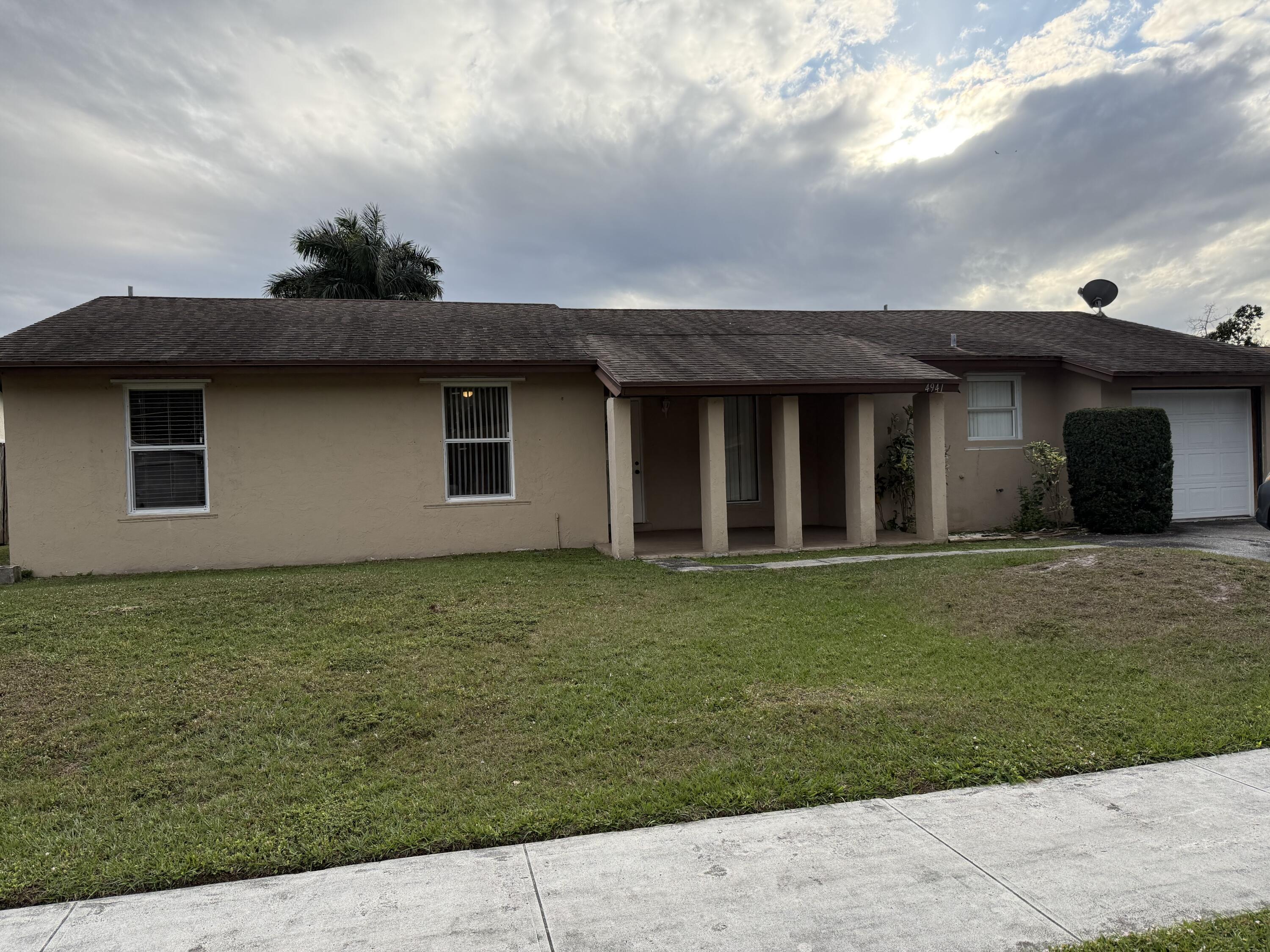 4941 Marbella Road North West Palm Beach, FL 33417 - Photo 12 of 12 a backyard of a house with lots of green space